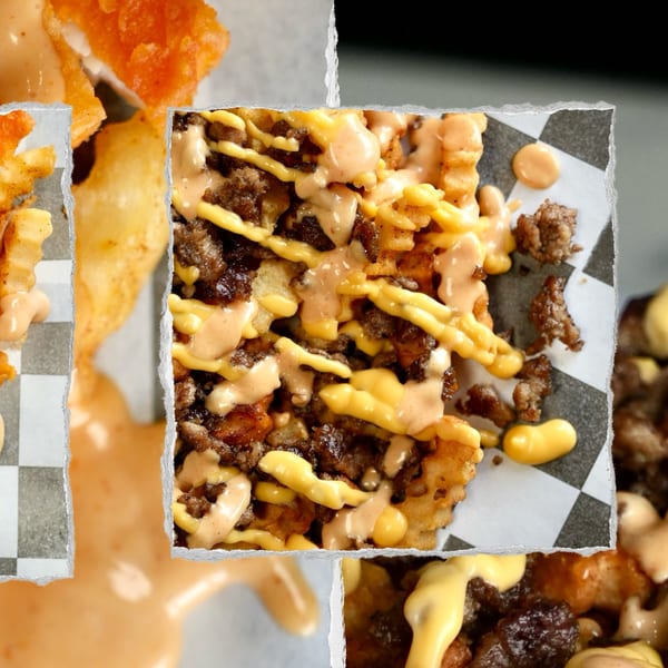 Close-up of Slaw Burger's loaded waffle fries with ground beef, cheese sauce, and special sauce.