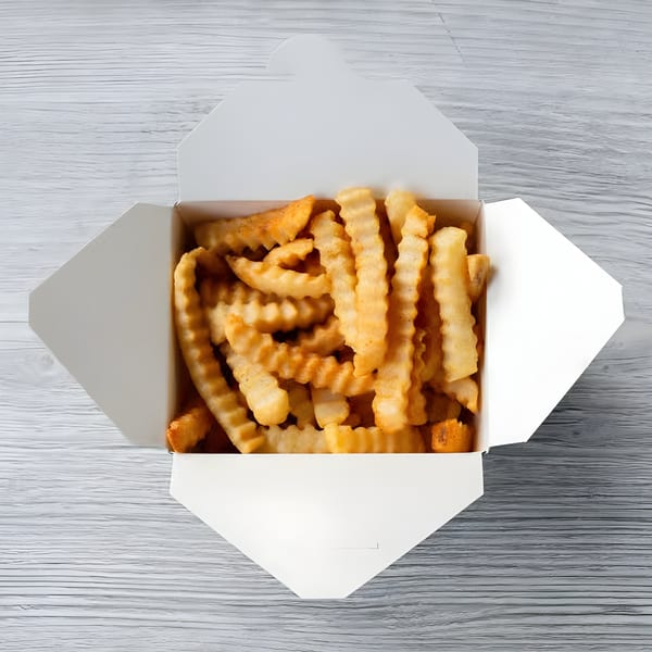 A white takeout box filled with golden, crinkle-cut Slaw Burger fries on a light wooden surface.