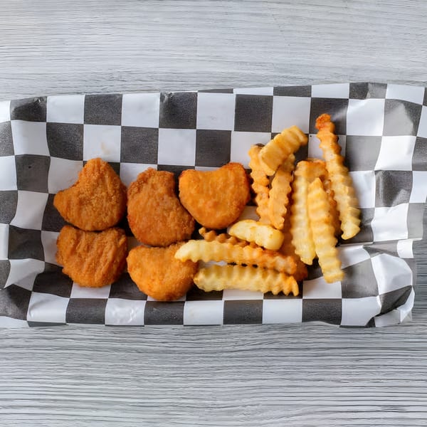 Crispy chicken nuggets and crinkle-cut fries served in a checkered paper-lined basket.