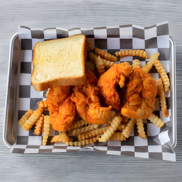 Slaw Burger's fried chicken tenders, crinkle-cut fries, and a slice of white bread on a tray.
