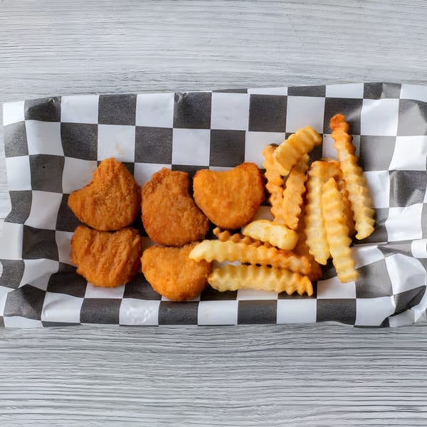 Slaw Burger's chicken nuggets and crinkle-cut fries in a checkered paper basket.